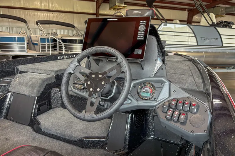 Slide: The Image of 2026 Skeeter ZXE20 boat dashboard with steering wheel and control panel. - 8
