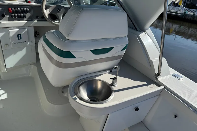 Slide: The Image of 1998 Formula 34 Performance Cruiser cockpit with steering, seat, and sink. - 16