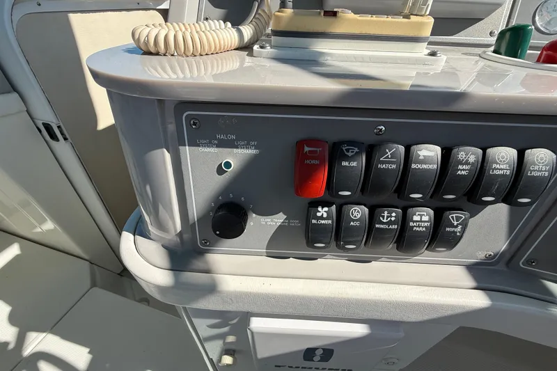 Slide: The Image of Control panel of a 1998 Formula 34 Performance Cruiser boat with various switches. - 21