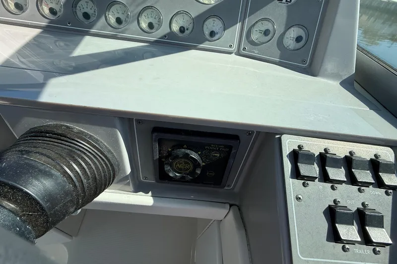 Slide: The Image of Control panel of a 1998 Formula 34 Performance Cruiser with gauges and switches. - 22