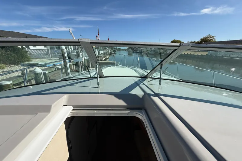 Slide: The Image of 1998 Formula 34 Performance Cruiser docked, view from cockpit to bow and waterway. - 23