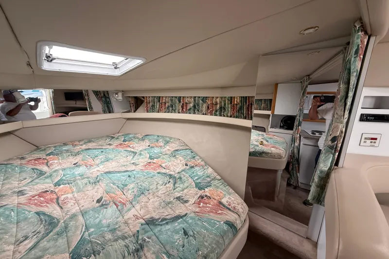 Slide: The Image of 1998 Formula 34 Performance Cruiser interior with patterned bedding and compact cabin space. - 25