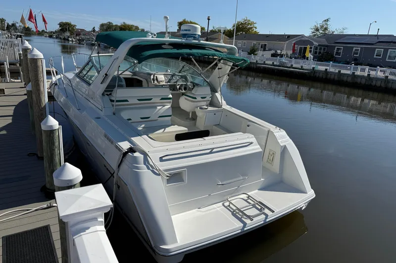 Slide: The Image of 1998 Formula 34 Performance Cruiser docked at a marina, featuring a sleek white design. - 3