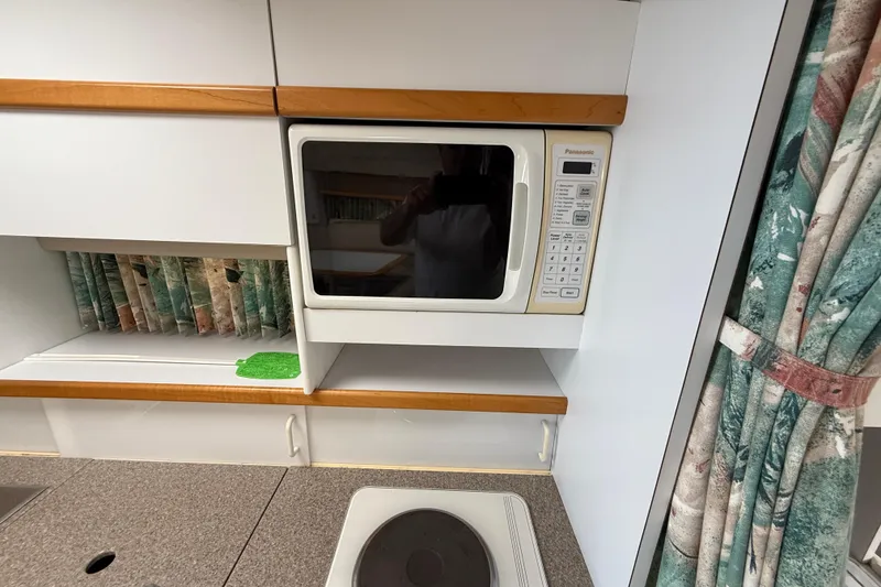 Slide: The Image of 1998 Formula 34 Performance Cruiser kitchen with microwave and stove. - 32