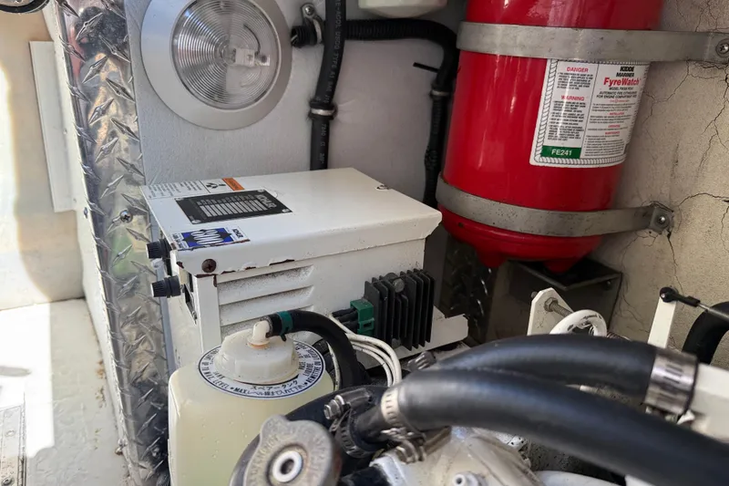 Slide: The Image of Engine compartment of a 1998 Formula 34 Performance Cruiser with fire extinguisher and equipment. - 38