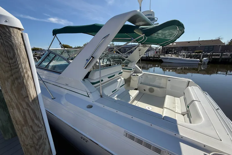 Slide: The Image of 1998 Formula 34 Performance Cruiser docked, featuring spacious seating and green canopy. - 4