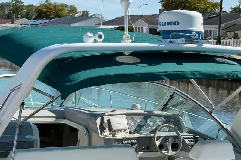 Slide: The Image of 1998 Formula 34 Performance Cruiser cockpit with green canopy and navigation equipment. - 6