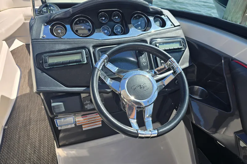 Slide: The Image of 2014 Monterey 288 Super Sport boat dashboard with steering wheel and instrument panel. - 10