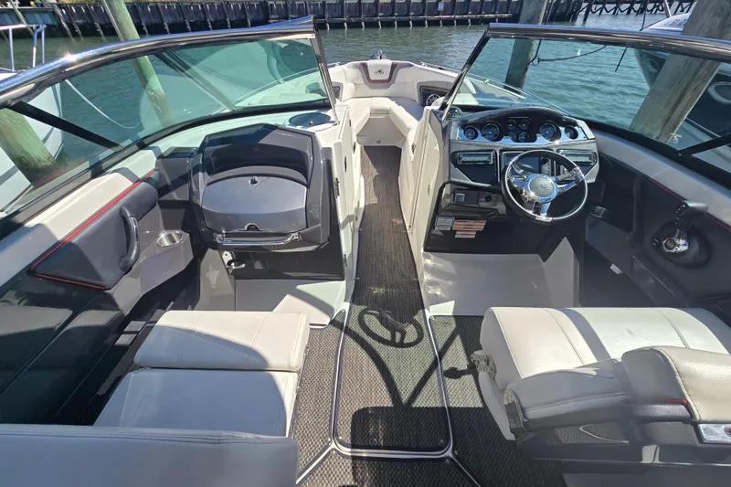 Slide: The Image of Interior of a 2014 Monterey 288 Super Sport boat with sleek seating and modern dashboard. - 11
