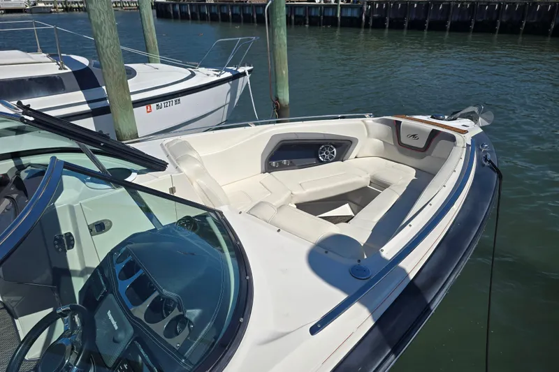 Slide: The Image of 2014 Monterey 288 Super Sport boat docked, featuring spacious seating and sleek design. - 16