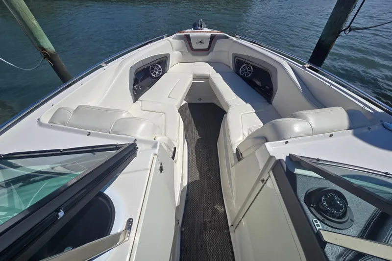Slide: The Image of 2014 Monterey 288 Super Sport boat interior with white seating and water view. - 17