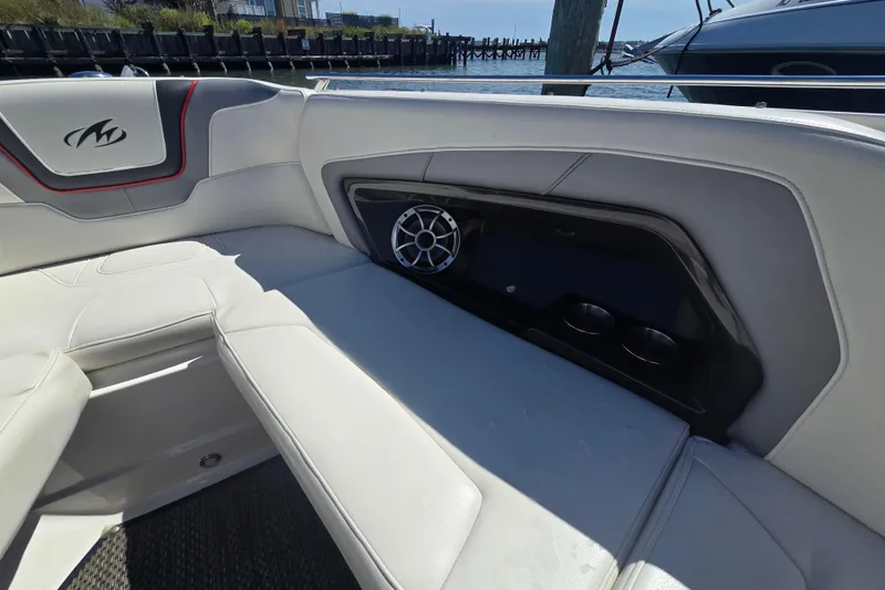 Slide: The Image of Interior of a 2014 Monterey 288 Super Sport boat with white seating and speaker. - 19
