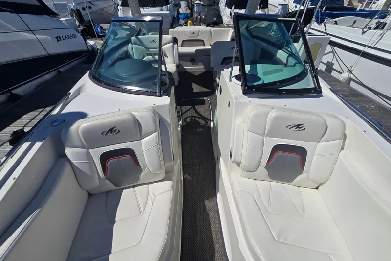 Slide: The Image of 2014 Monterey 288 Super Sport boat interior with white seating and glass windshields. - 21