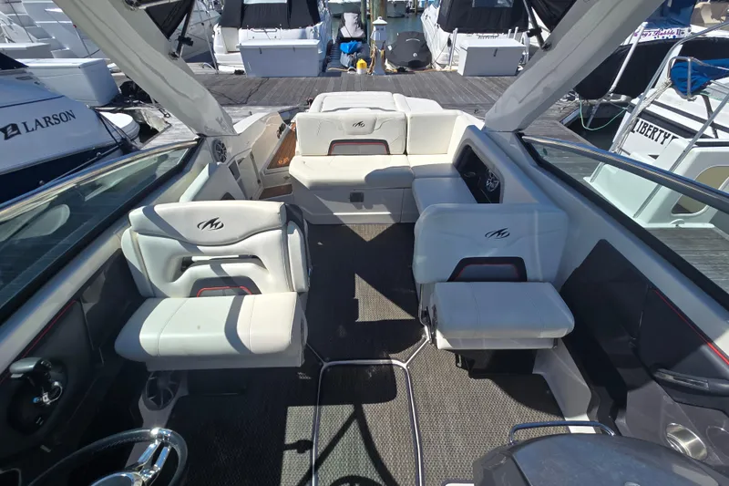 Slide: The Image of Interior of a 2014 Monterey 288 Super Sport boat with white seating and sleek design. - 22
