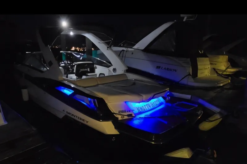 Slide: The Image of 2014 Monterey 288 Super Sport boat with blue LED lights at night. - 26