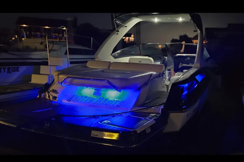 Slide: The Image of 2014 Monterey 288 Super Sport boat with blue LED lights at night. - 27