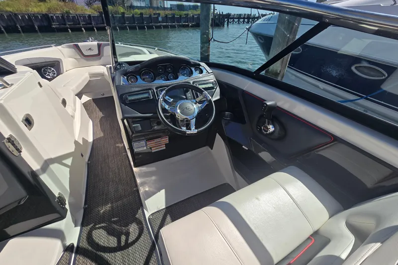 Slide: The Image of 2014 Monterey 288 Super Sport boat interior with steering wheel and seating. - 9