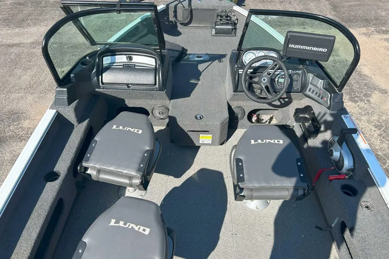 Slide: The Image of 2023 Lund 1775 Adventure Sport boat interior with seating and steering console. - 2