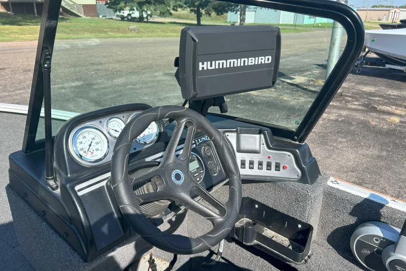 Slide: The Image of 2023 Lund 1775 Adventure Sport boat dashboard with Humminbird fish finder and steering wheel. - 3