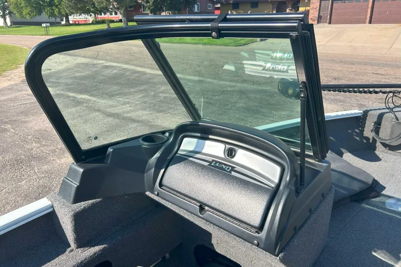 Slide: The Image of 2023 Lund 1775 Adventure Sport boat dashboard with windshield, parked outdoors. - 6