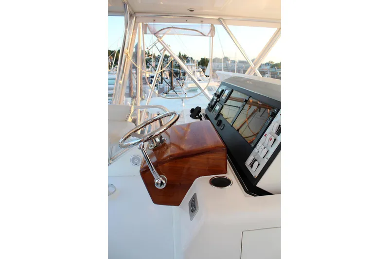 Slide: The Image of Helm of 2006 Egg Harbor 43 Sport Yacht with polished wood and modern controls. - 17