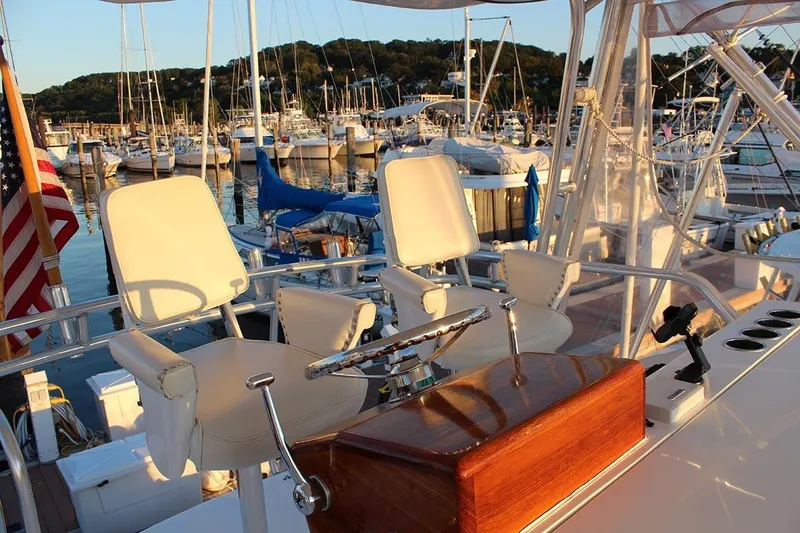 Slide: The Image of 2006 Egg Harbor 43 Sport Yacht helm with marina view at sunset. - 18