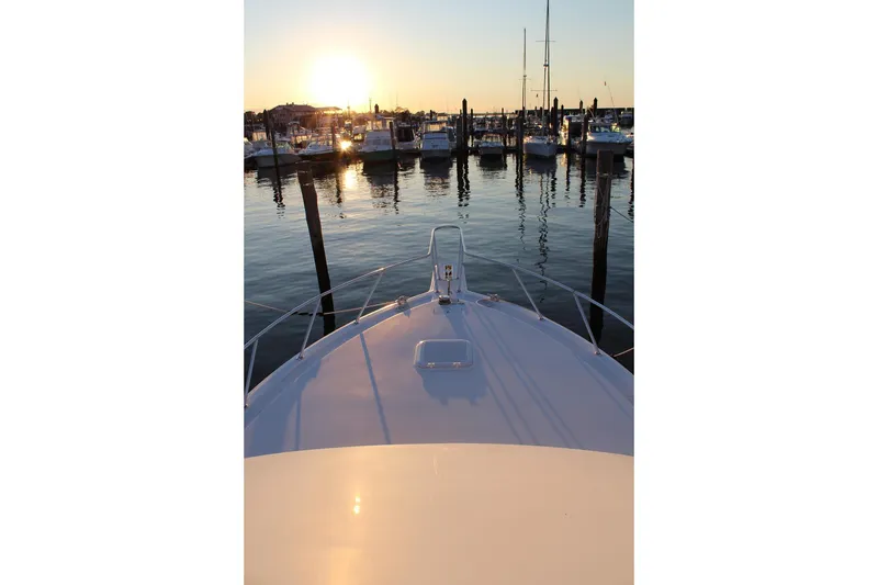 Slide: The Image of Bow view of 2006 Egg Harbor 43 Sport Yacht at sunset in marina. - 19