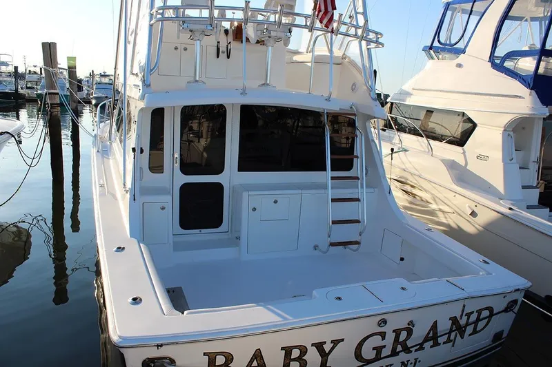 Slide: The Image of 2006 Egg Harbor 43 Sport Yacht docked, showcasing spacious deck and ladder. - 20