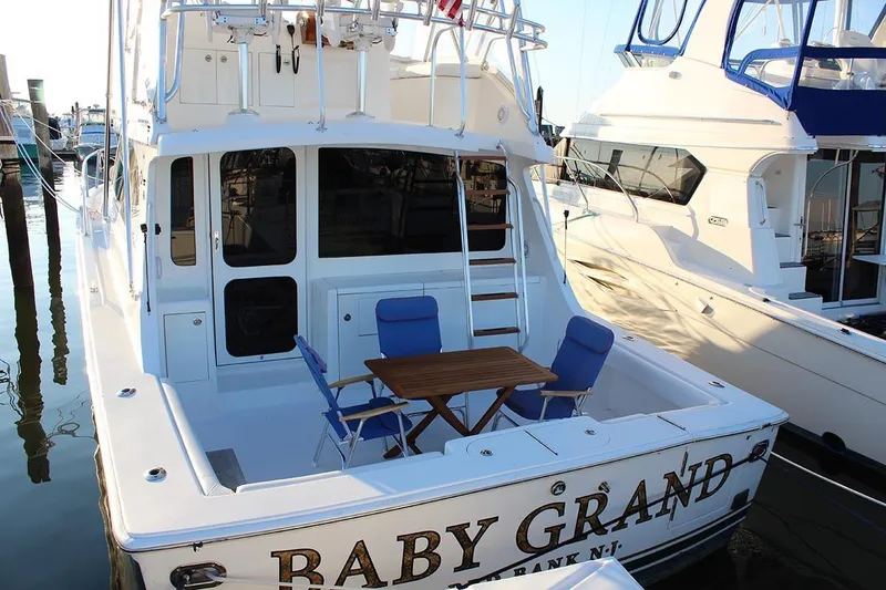 Slide: The Image of 2006 Egg Harbor 43 Sport Yacht docked with seating area and table on deck. - 21