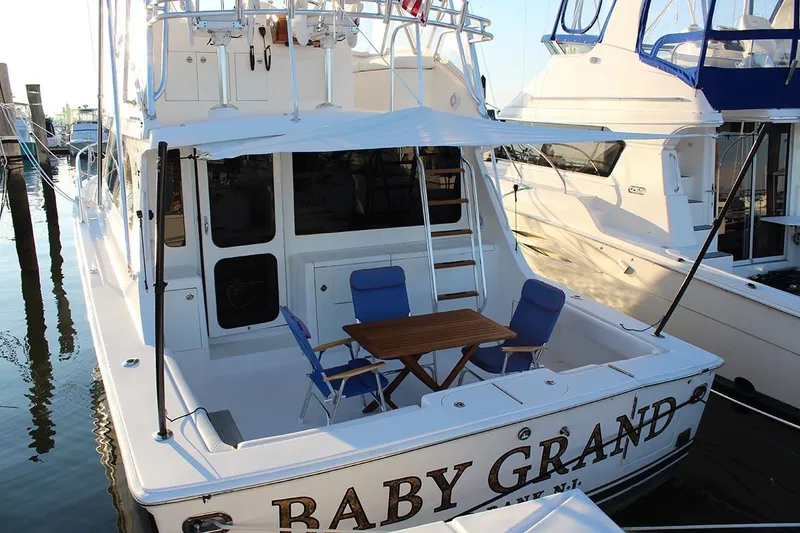Slide: The Image of 2006 Egg Harbor 43 Sport Yacht docked with seating area and table on deck. - 22