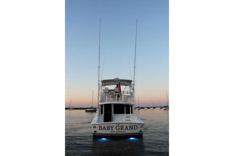 Slide: The Image of 2006 Egg Harbor 43 Sport Yacht at sunset with illuminated water. - 24