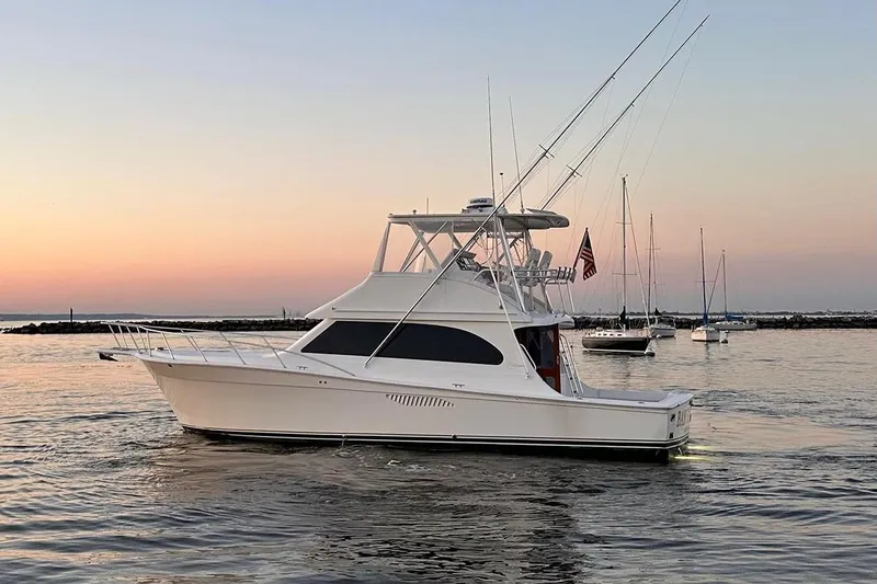 Slide: The Image of 2006 Egg Harbor 43 Sport Yacht at sunset, anchored in calm waters. - 27