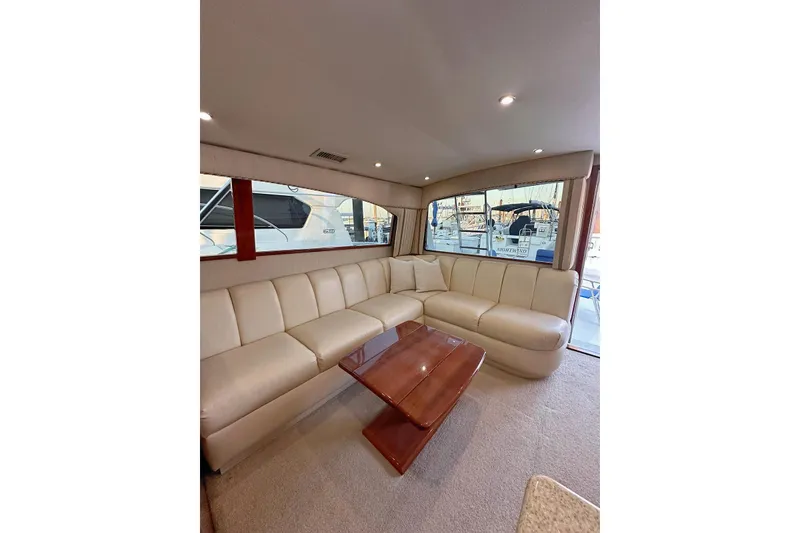 Slide: The Image of Luxurious interior of 2006 Egg Harbor 43 Sport Yacht with cream leather seating and wooden table. - 3
