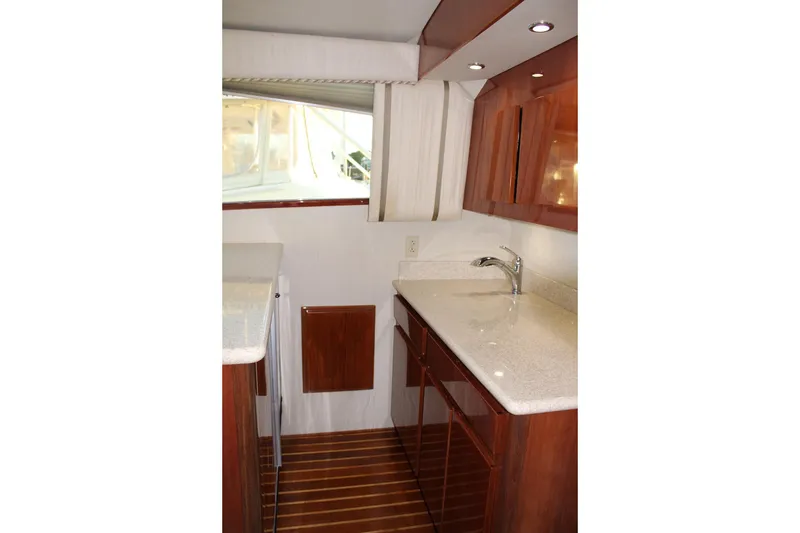 Slide: The Image of Interior of 2006 Egg Harbor 43 Sport Yacht with sleek wood cabinetry and modern fixtures. - 8