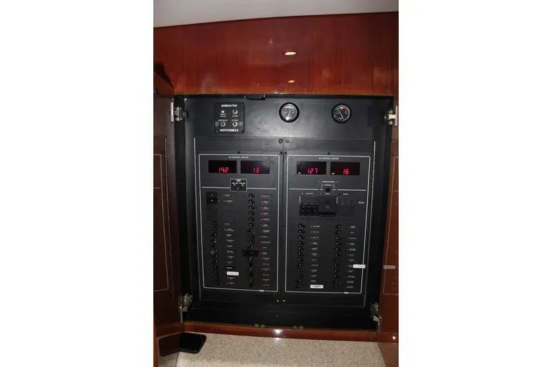 Slide: The Image of Electrical control panel on 2006 Egg Harbor 43 Sport Yacht, featuring gauges and switches. - 9