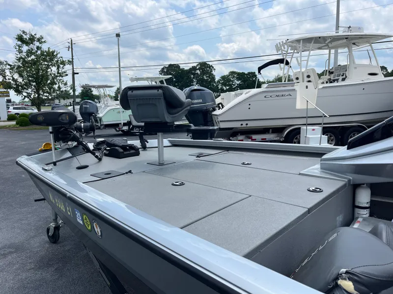 Slide: The Image of 2022 Vexus AVX189 boat with spacious deck, parked outdoors under cloudy sky. - 14