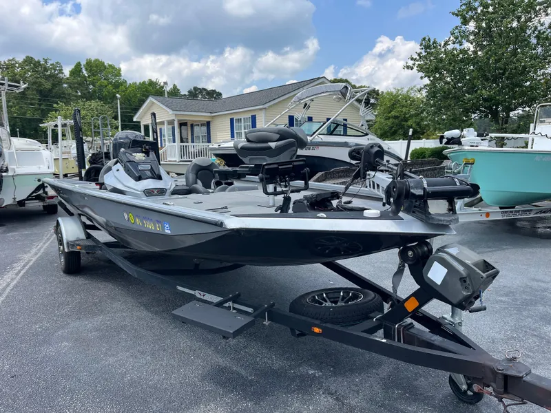 Slide: The Image of 2022 Vexus AVX189 boat on trailer, parked outdoors near a house. - 2