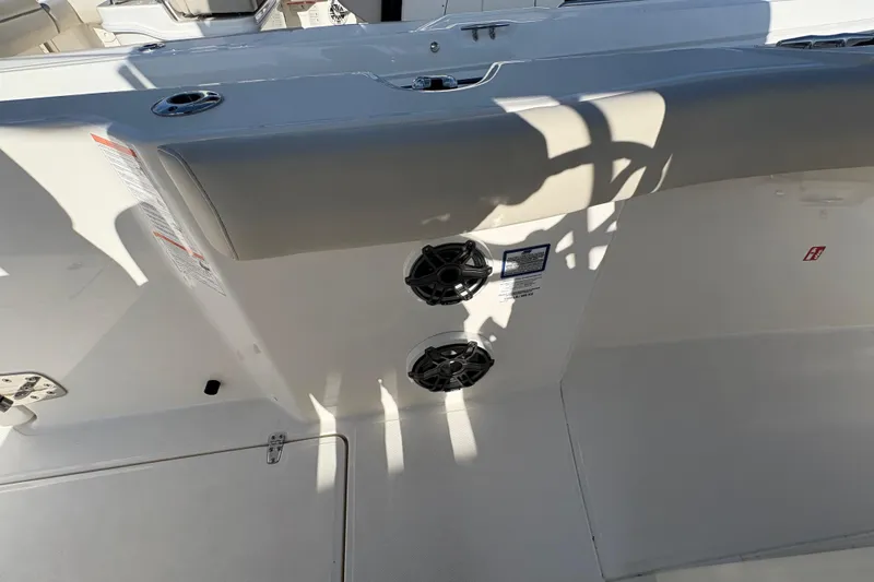 Slide: The Image of 2026 Boston Whaler 280 Outrage boat interior with speakers and seating area. - 13