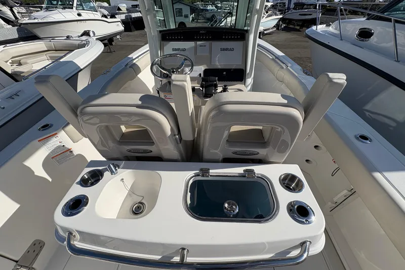 Slide: The Image of 2026 Boston Whaler 280 Outrage boat interior with helm and seating area. - 4