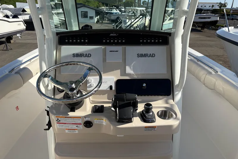 Slide: The Image of 2026 Boston Whaler 280 Outrage helm with Simrad electronics and Mercury controls. - 7