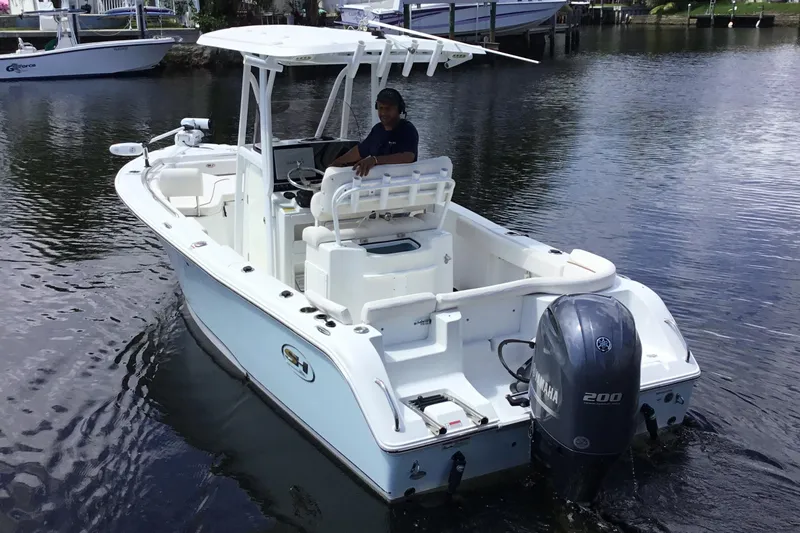 Slide: The Image of 2020 Sea Hunt Ultra 225 boat on water, featuring Yamaha 200 engine. - 10