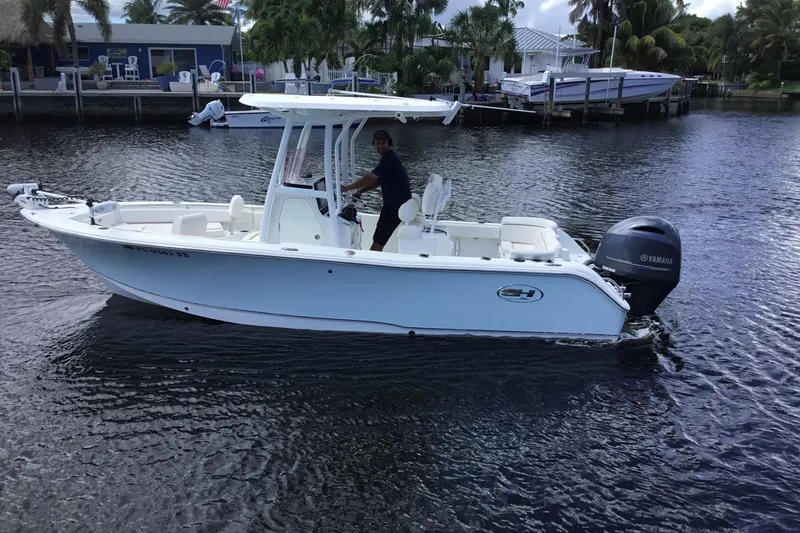 Slide: The Image of 2020 Sea Hunt Ultra 225 boat on water with Yamaha outboard motor. - 14