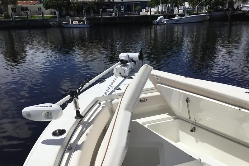 Slide: The Image of 2020 Sea Hunt Ultra 225 boat with Minn Kota trolling motor on calm water. - 18