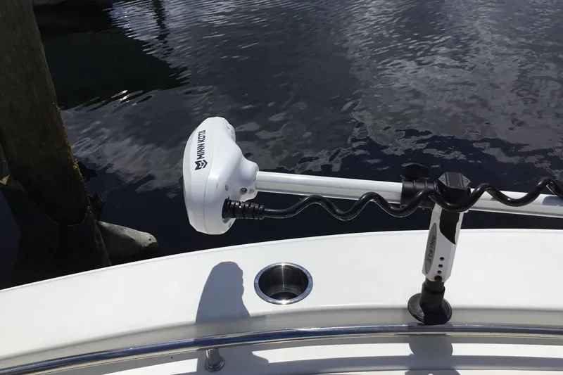 Slide: The Image of 2020 Sea Hunt Ultra 225 boat with Minn Kota trolling motor on calm water. - 20