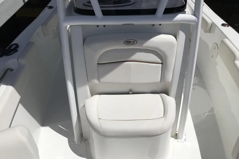 Slide: The Image of 2020 Sea Hunt Ultra 225 boat interior with white cushioned seating. - 22