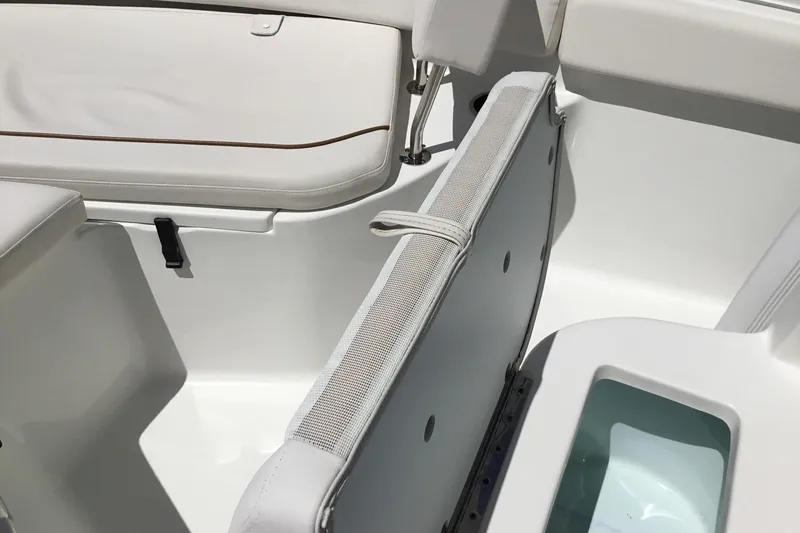 Slide: The Image of 2020 Sea Hunt Ultra 225 boat interior with white seating and storage compartment. - 24