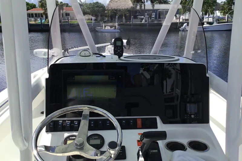 Slide: The Image of Cockpit view of 2020 Sea Hunt Ultra 225 boat with steering wheel and control panel. - 29