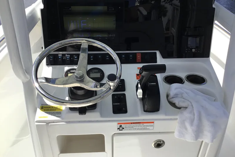 Slide: The Image of 2020 Sea Hunt Ultra 225 boat dashboard with steering wheel and controls. - 30