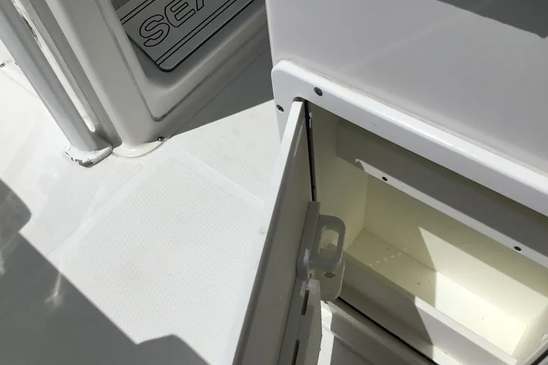 Slide: The Image of Open storage compartment on a 2020 Sea Hunt Ultra 225 boat deck. - 31