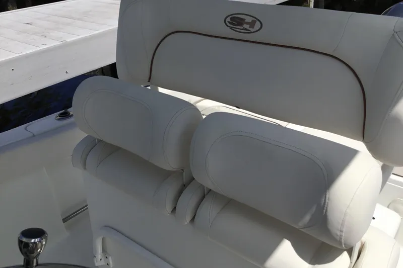 Slide: The Image of 2020 Sea Hunt Ultra 225 boat seat with white upholstery and logo. - 32
